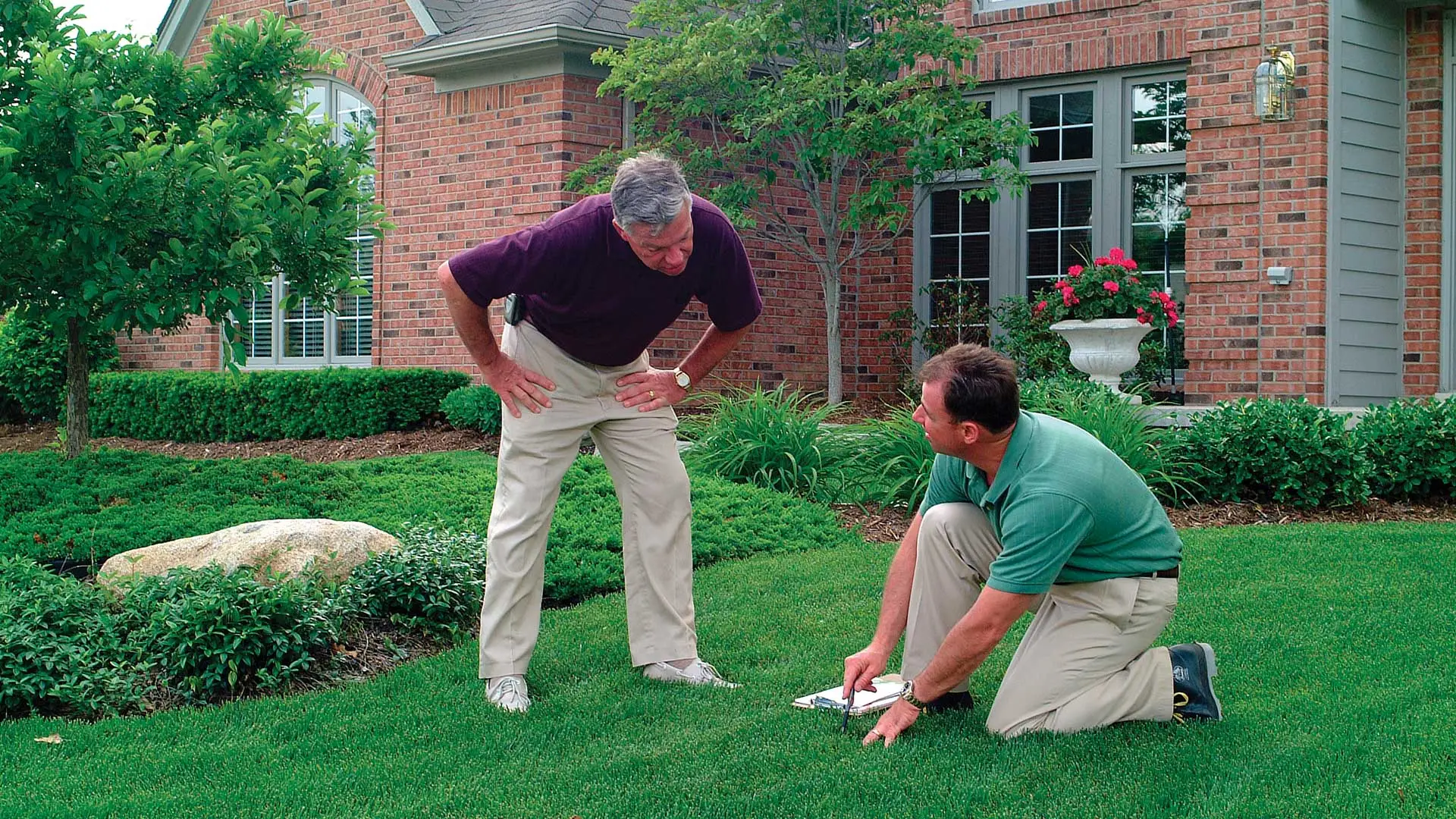 Homeowner being taught about lawn care benefits in Berkeley Heights, NJ.